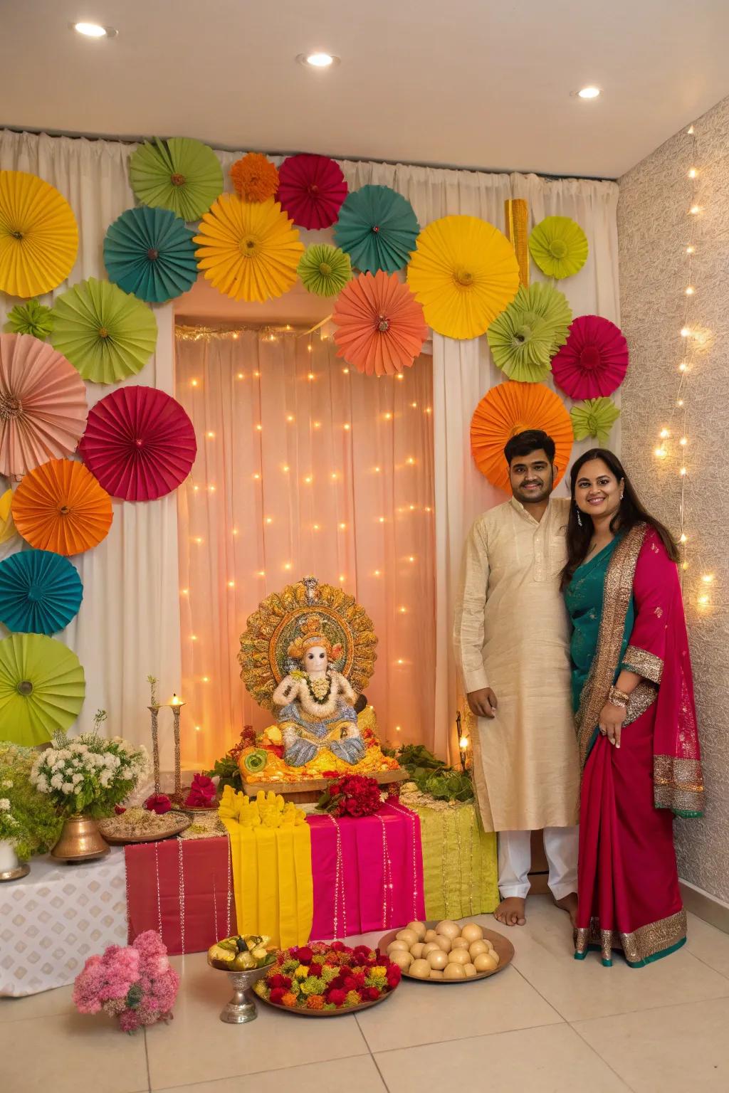 A festive Ganpati backdrop featuring vibrant paper fans and fabric drapes.