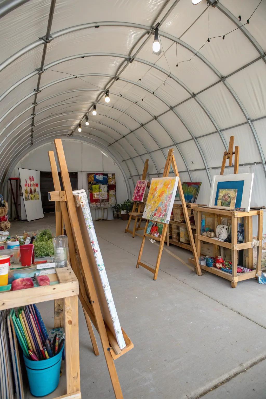 A spacious artistic studio setup inside a Quonset hut.