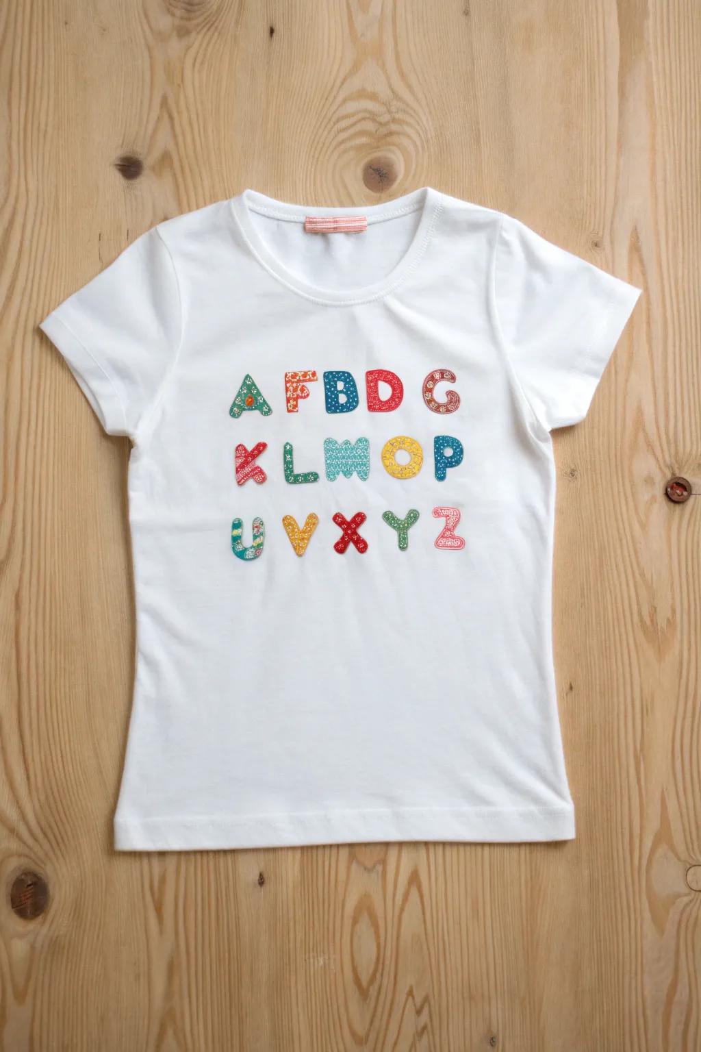 Learn your ABCs in style with this charming, handcrafted alphabet t-shirt!